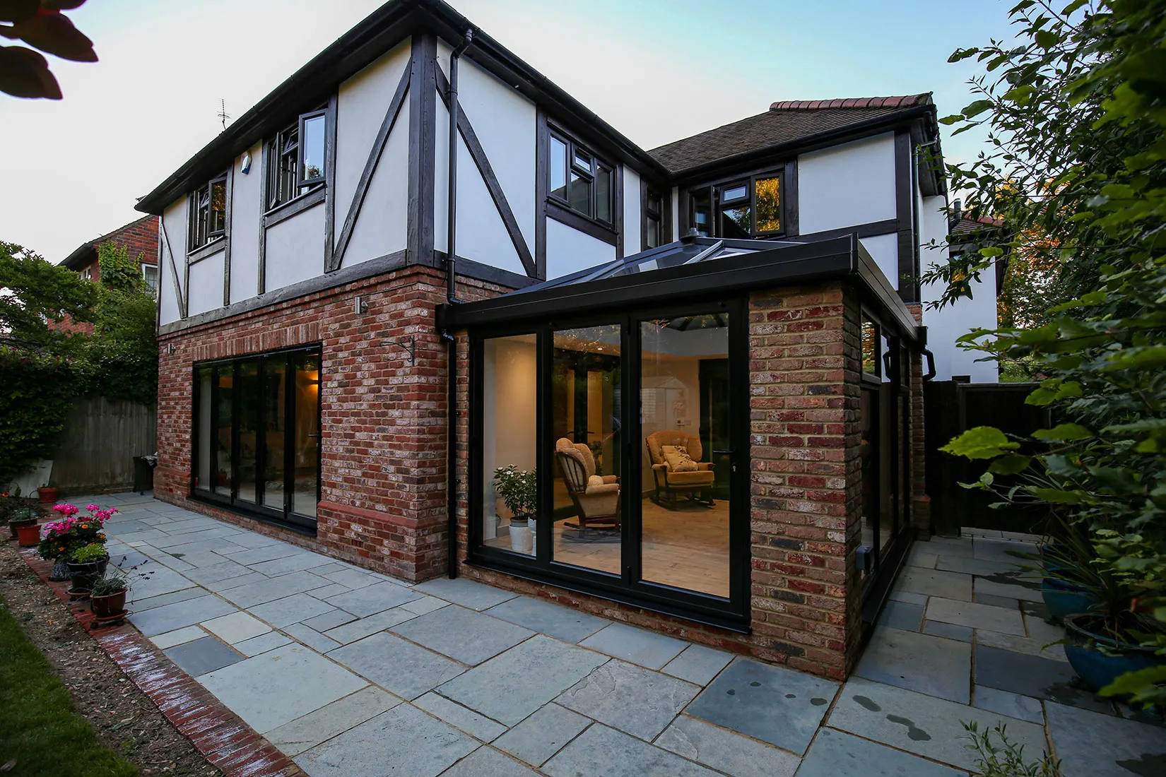 a brick house with a patio and patio furniture